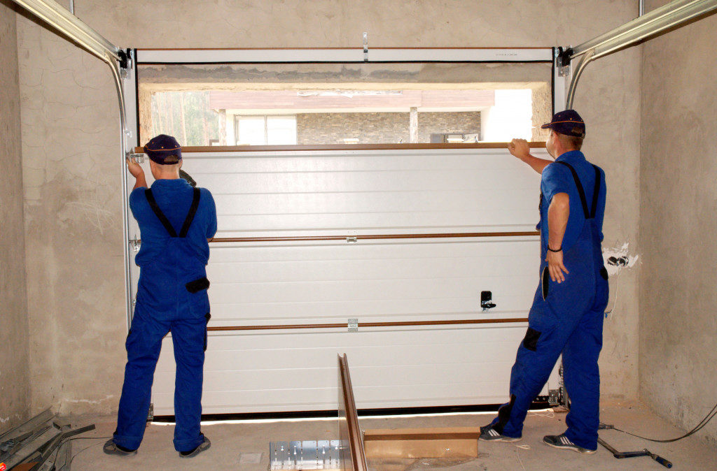 men repairing a garage door